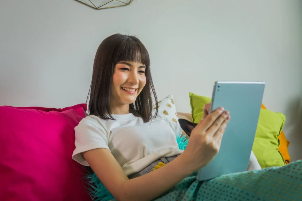 A happy woman using a tablet